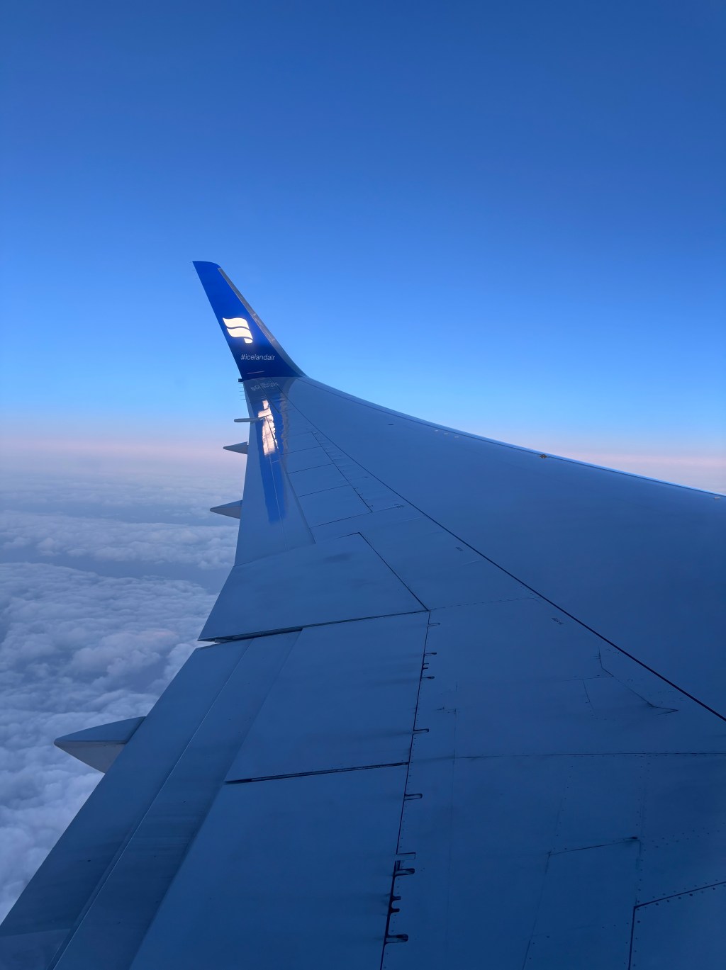 A photo of a plane wing featuring #Icelandair, from our flight into Keflavík airport.